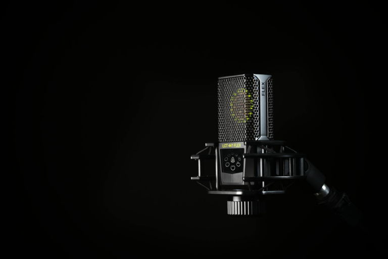 A detailed studio shot of a condenser microphone against a black background, emphasizing modern audio technology.